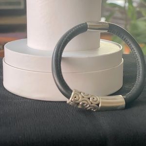 Leather magnetic bracelet with silver-tone removable charm.
